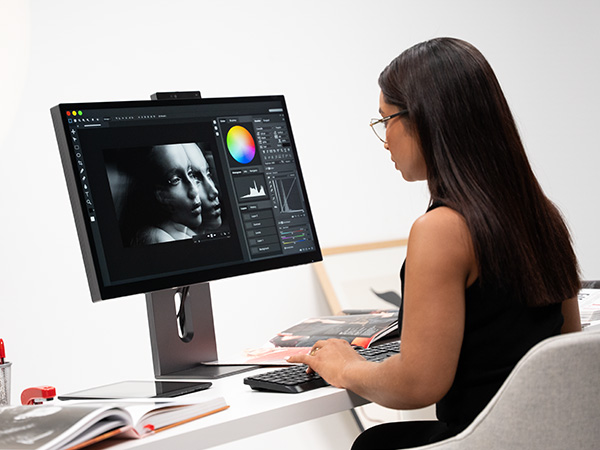 a woman editing and crafting assets with Philips monitor